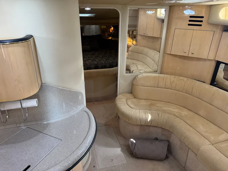 Slide: The Image of Interior of 1999 Sea Ray 380 Sundancer with beige sofa and kitchenette. - 19