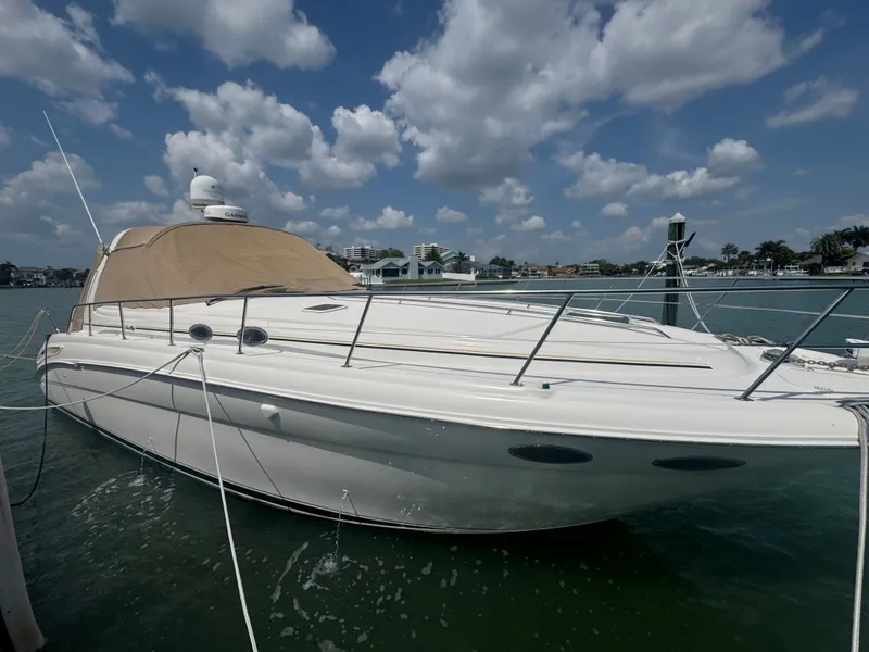 Slide: The Image of 1999 Sea Ray 380 Sundancer yacht docked under cloudy sky. - 2