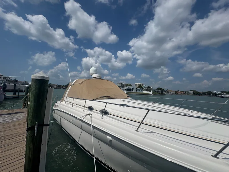 Slide: The Image of 1999 Sea Ray 380 Sundancer docked under a blue sky. - 3
