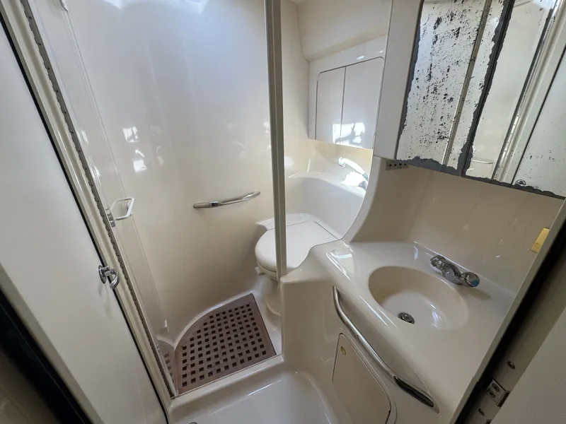 Slide: The Image of 1999 Sea Ray 380 Sundancer bathroom with shower and sink. - 32