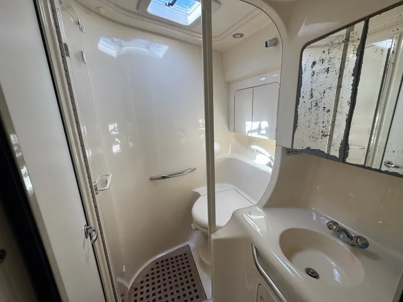Slide: The Image of 1999 Sea Ray 380 Sundancer bathroom with shower and sink. - 33