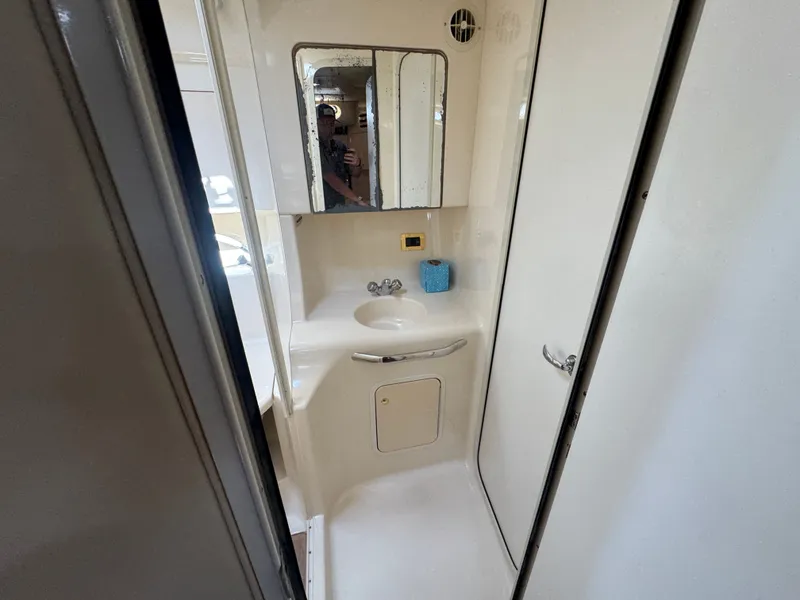 Slide: The Image of Sea Ray 380 Sundancer 1999 bathroom with mirror and sink. - 35