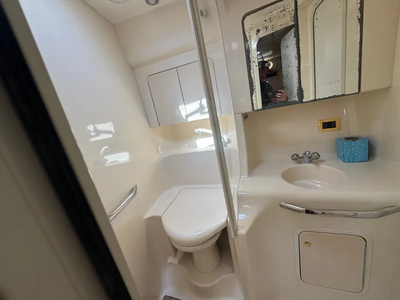 Slide: The Image of Sea Ray 380 Sundancer 1999 bathroom with toilet and sink. - 41