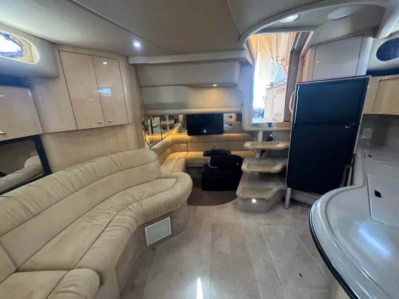 Slide: The Image of Interior of 1999 Sea Ray 380 Sundancer with beige sofa and stairs. - 43