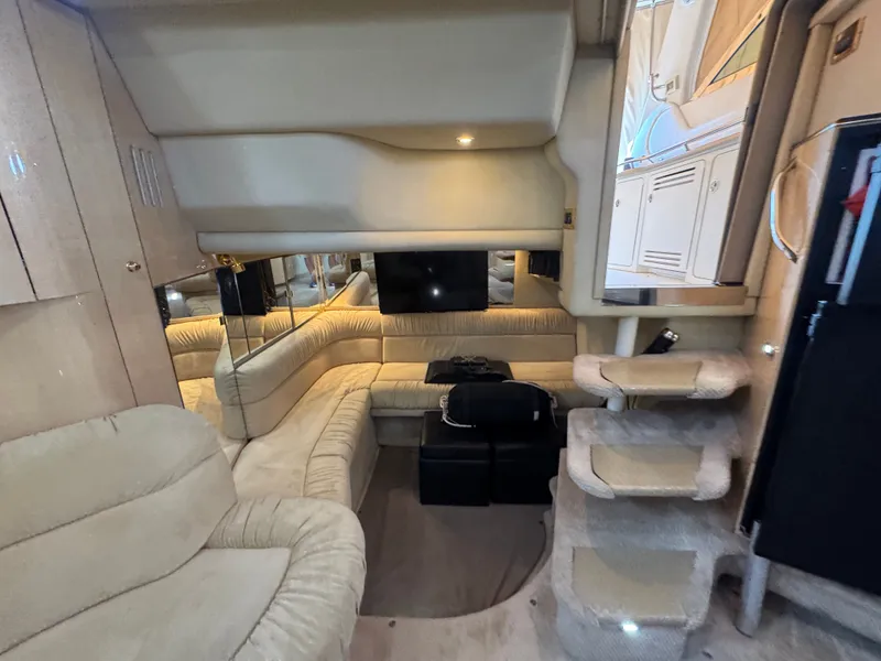 Slide: The Image of Interior of 1999 Sea Ray 380 Sundancer with beige sofa and steps. - 44