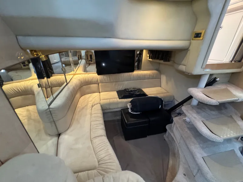 Slide: The Image of Interior of 1999 Sea Ray 380 Sundancer with beige sofa and TV. - 47