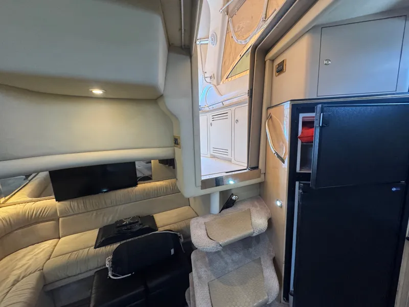 Slide: The Image of Interior of a 1999 Sea Ray 380 Sundancer yacht with sofa and refrigerator. - 48