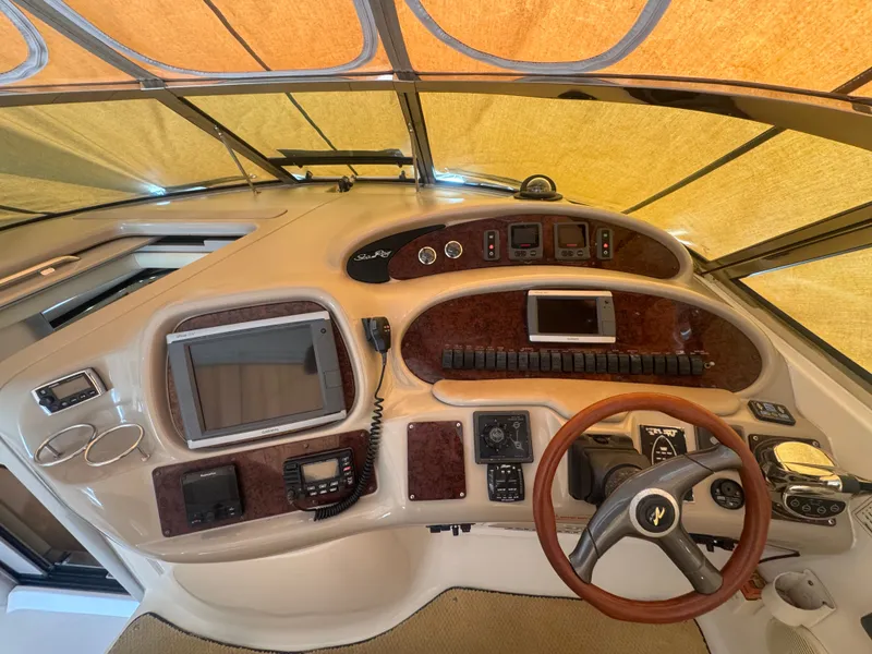 Slide: The Image of 1999 Sea Ray 380 Sundancer cockpit with steering wheel and instruments. - 9