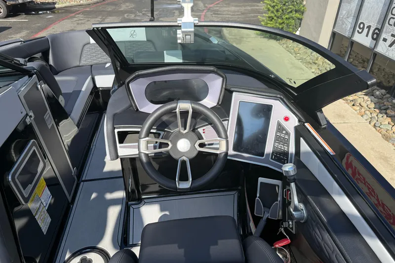 Slide: The Image of 2024 MasterCraft X24 boat cockpit with modern steering and touchscreen controls. - 12