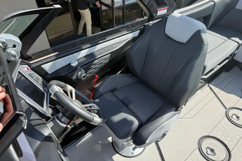 Slide: The Image of 2024 MasterCraft X24 boat cockpit with modern steering and seating. - 13