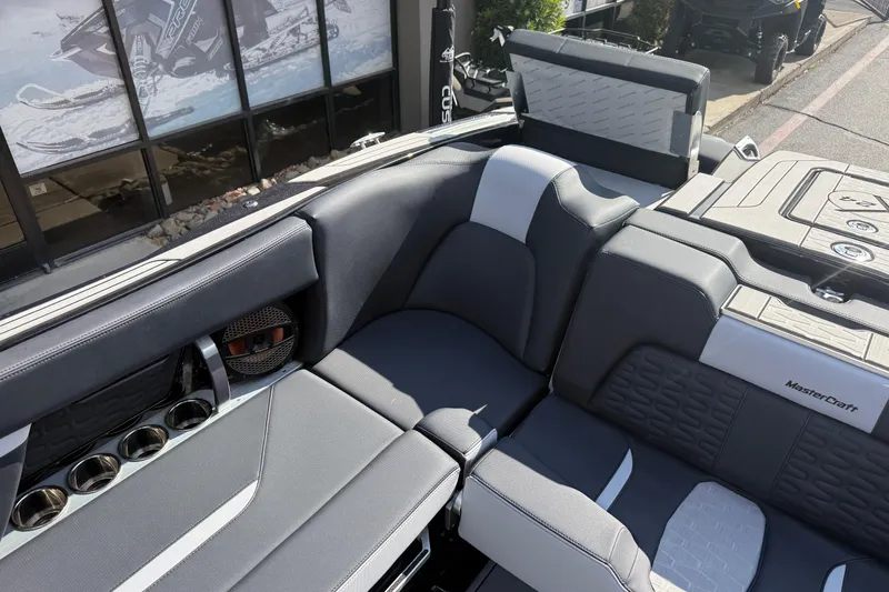 Slide: The Image of 2024 MasterCraft X24 boat interior with sleek seating and cup holders. - 16