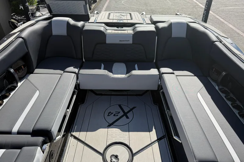 Slide: The Image of 2024 MasterCraft X24 boat interior with sleek seating and modern design. - 17