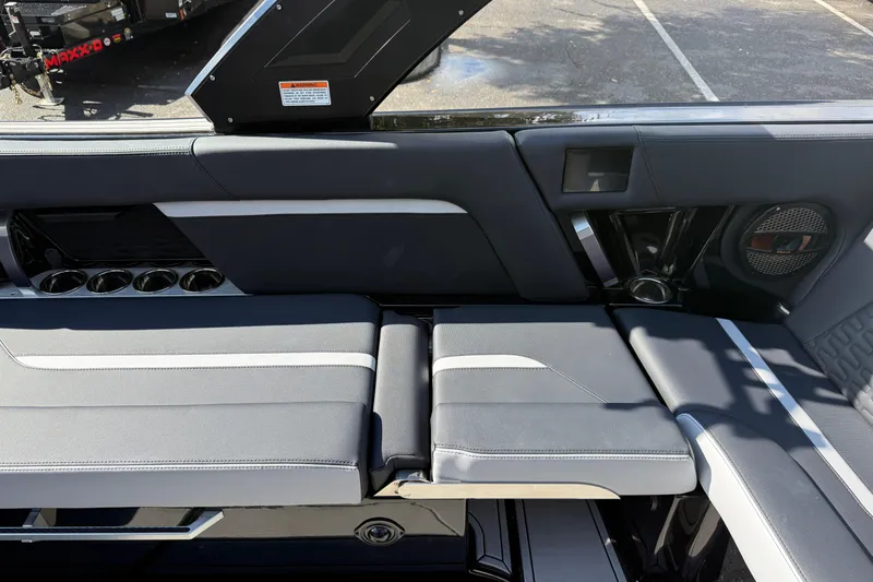 Slide: The Image of 2024 MasterCraft X24 interior seating with cup holders and speaker system. - 20