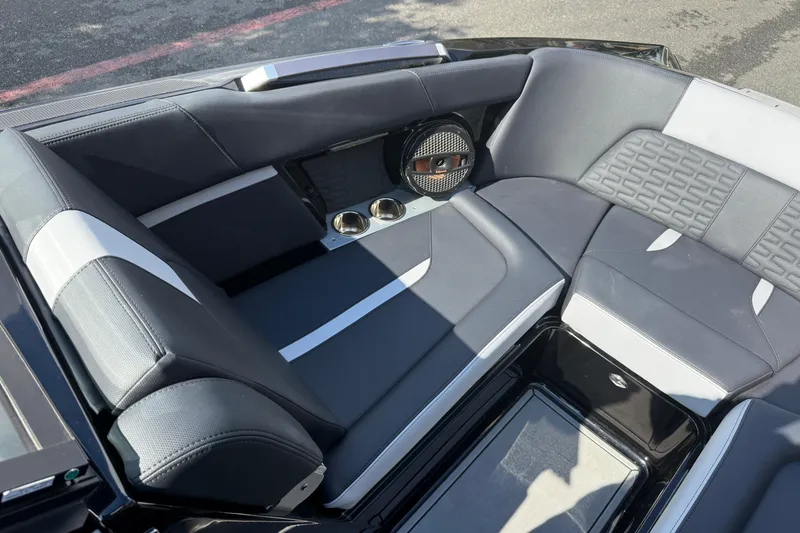 Slide: The Image of 2024 MasterCraft X24 boat interior with sleek seating and integrated speaker system. - 25