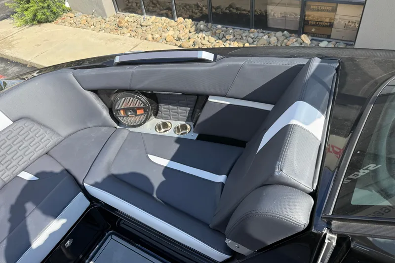 Slide: The Image of 2024 MasterCraft X24 boat interior with sleek seating and built-in speaker system. - 26