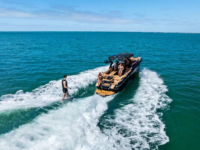 Slide: The Image of 2024 MasterCraft X24 boat with mounted speakers and tower release mechanism. - 30