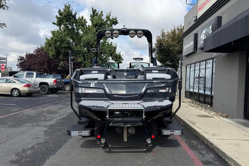Slide: The Image of 2024 MasterCraft X24 boat parked outside dealership, showcasing sleek design and modern features. - 4