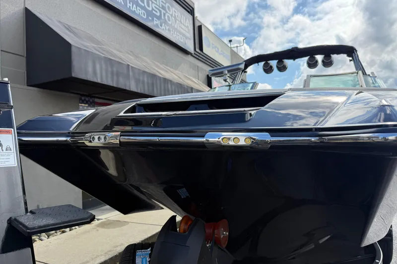 Slide: The Image of 2024 MasterCraft X24 boat displayed outdoors under a cloudy sky. - 7