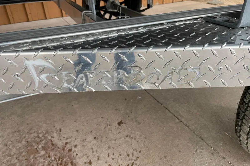 Slide: The Image of Reaper Boats 550 Timber Reaper 2026 logo on metal surface. - 6