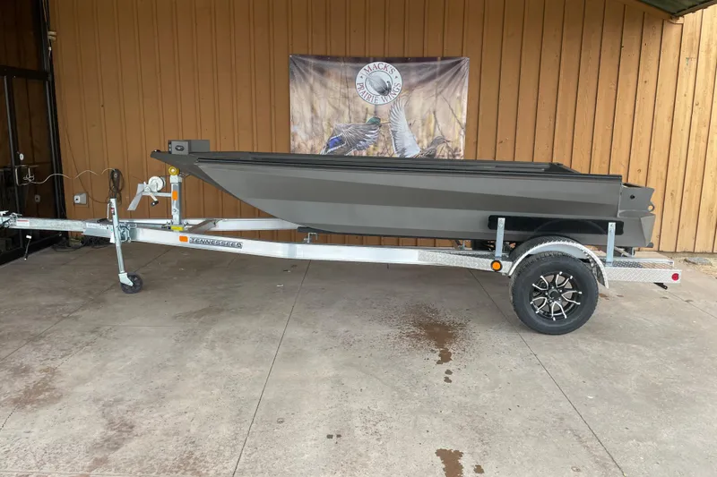 Slide: The Image of 2026 Reaper Boats 550 Timber Reaper on trailer, displayed outdoors. - 9