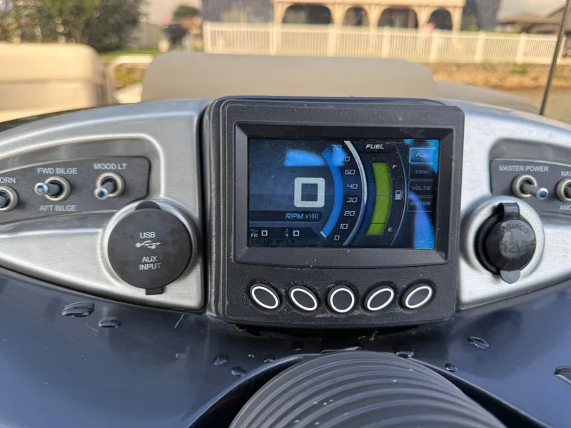 Slide: The Image of Dashboard of a 2000 Sanpan 25 boat with tachometer and controls. - 10