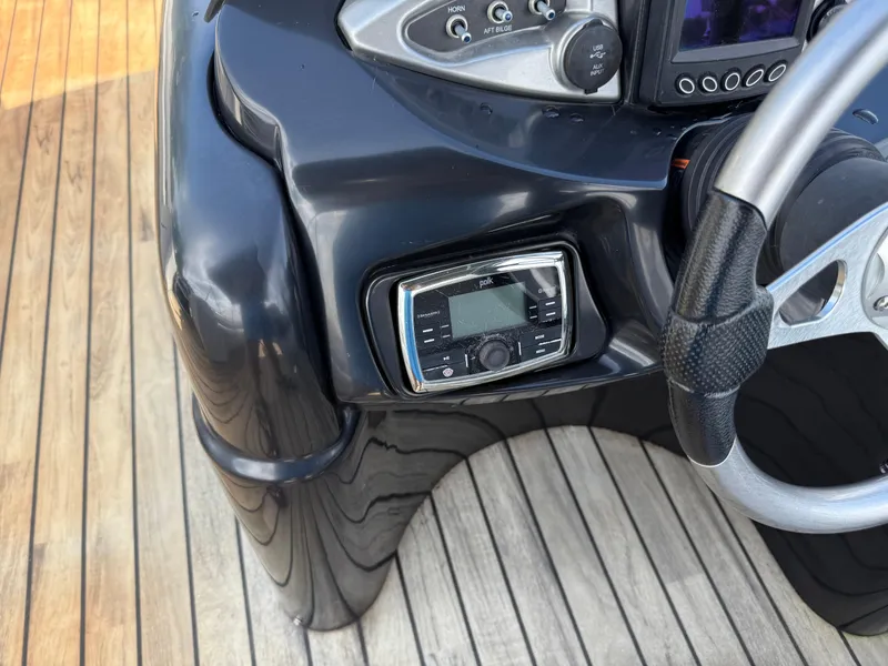 Slide: The Image of Dashboard of a 2000 Sanpan 25 boat featuring Polk audio system. - 8