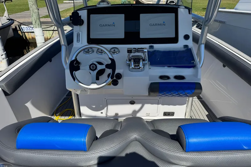 Slide: The Image of 2008 Donzi 32 ZF Open boat cockpit with Garmin navigation system and blue accents. - 7