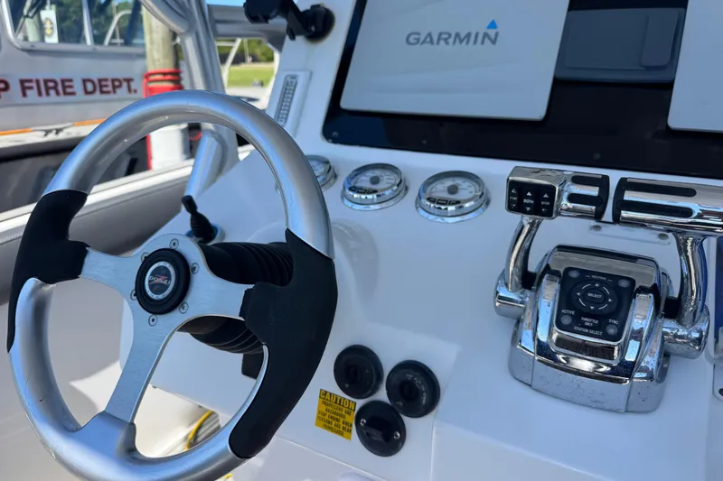 Slide: The Image of Steering wheel and controls of a 2008 Donzi 32 ZF Open boat with Garmin display. - 9