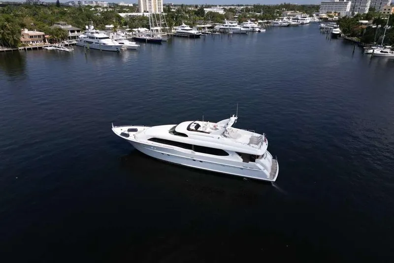 Slide: The Image of 2001 Lazzara Motoryacht cruising in a marina with other yachts nearby. - 13