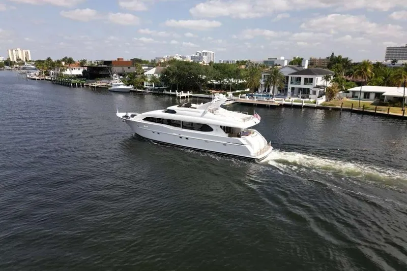 Slide: The Image of 2001 Lazzara Motoryacht cruising on a scenic waterway with waterfront homes. - 15