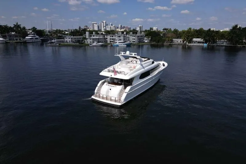 Slide: The Image of 2001 Lazzara Motoryacht cruising on calm waters with city skyline in background. - 16