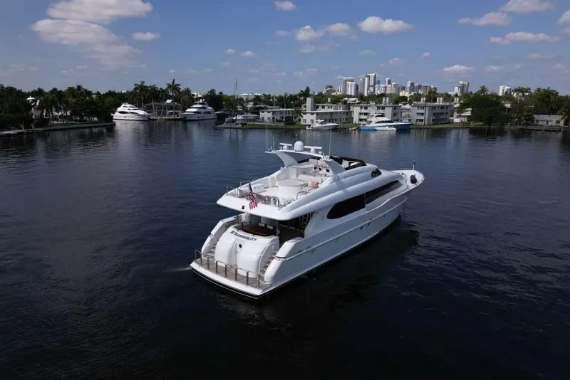 Slide: The Image of 2001 Lazzara Motoryacht cruising on calm waters near a coastal cityscape. - 17