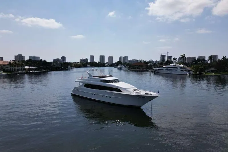 Slide: The Image of 2001 Lazzara Motoryacht cruising in a scenic waterfront setting with city skyline. - 18