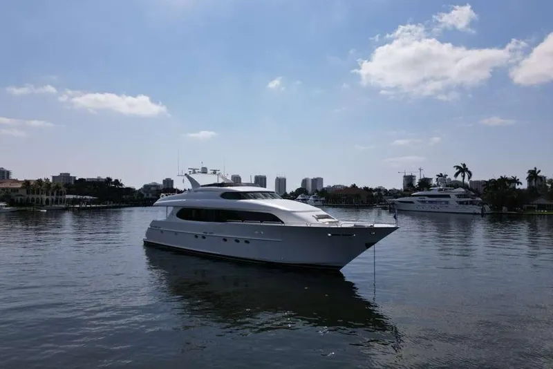 Slide: The Image of 2001 Lazzara Motoryacht on calm water with city skyline in background. - 23