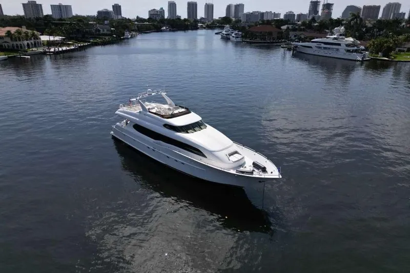 Slide: The Image of 2001 Lazzara Motoryacht cruising in a scenic waterfront cityscape. - 24