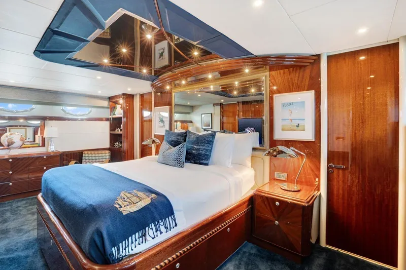 Slide: The Image of Luxurious 2001 Lazzara Motoryacht bedroom with elegant wood finishes and plush bedding. - 30
