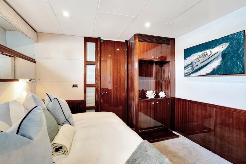 Slide: The Image of Luxurious 2001 Lazzara Motoryacht bedroom with elegant wood finishes and nautical decor. - 34