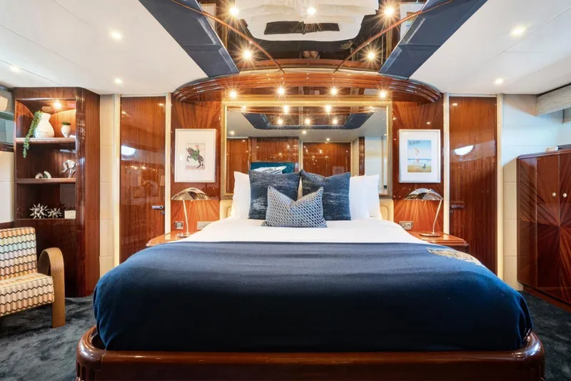 Slide: The Image of Luxurious 2001 Lazzara Motoryacht bedroom with elegant wood finishes and plush bedding. - 35