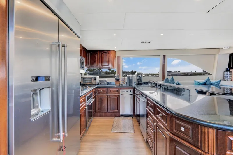 Slide: The Image of Luxurious kitchen interior of a 2001 Lazzara Motoryacht with modern appliances and elegant wood cabinetry. - 42