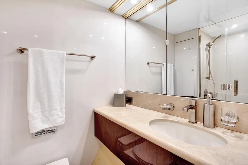 Slide: The Image of Luxurious bathroom on a 2001 Lazzara Motoryacht with elegant fixtures and marble countertop. - 43