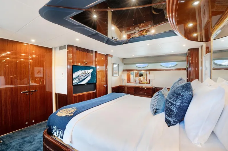 Slide: The Image of Luxurious 2001 Lazzara Motoryacht bedroom with elegant wood finishes and plush bedding. - 44