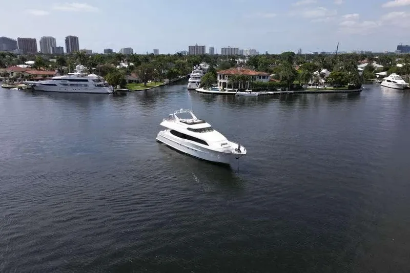 Slide: The Image of 2001 Lazzara Motoryacht cruising in a scenic waterfront area with luxury homes. - 7