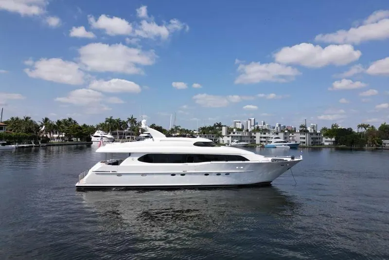 Slide: The Image of 2001 Lazzara Motoryacht on calm water under a clear blue sky. - 9