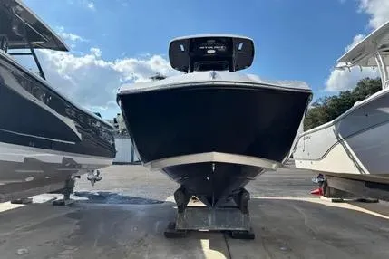 Slide: The Image of 2021 Yamaha Boats 255 FSH Sport E, front view, docked between two boats. - 9