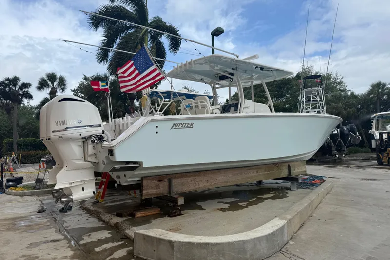 The Image of 2012 Jupiter 34 FS boat with Yamaha engine on dry dock, American flag displayed. - 0