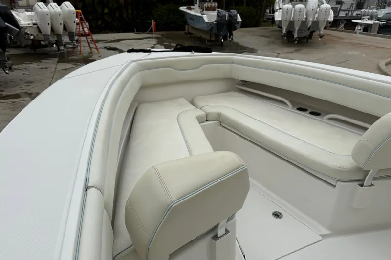 Slide: The Image of 2012 Jupiter 34 FS boat with white cushioned seating in the bow area. - 14