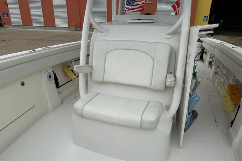 Slide: The Image of 2012 Jupiter 34 FS boat interior with white seating and storage compartments. - 15