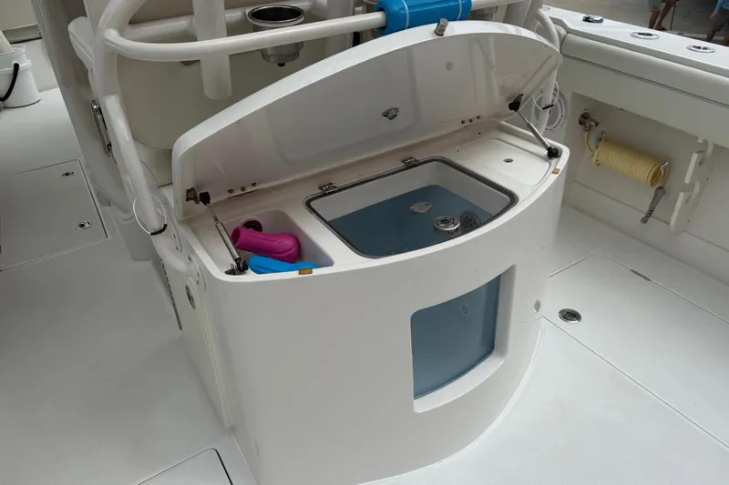 Slide: The Image of 2012 Jupiter 34 FS boat interior with open storage compartment and fishing gear. - 17