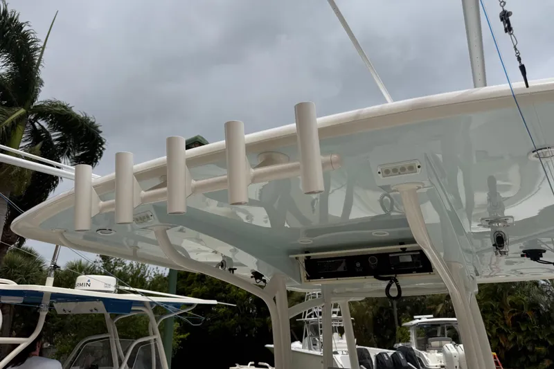 Slide: The Image of 2012 Jupiter 34 FS boat with rod holders and electronic equipment under cloudy sky. - 19