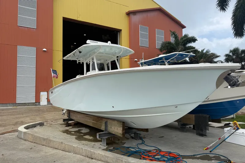 Slide: The Image of 2012 Jupiter 34 FS boat on dry dock near a large warehouse. - 2